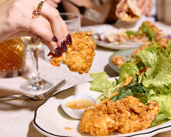 Hand grabbing chicken