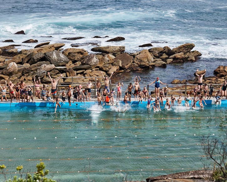 People jumping into ocean