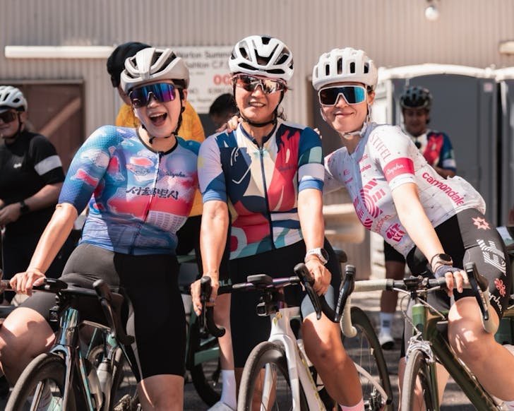 Three people cycling below