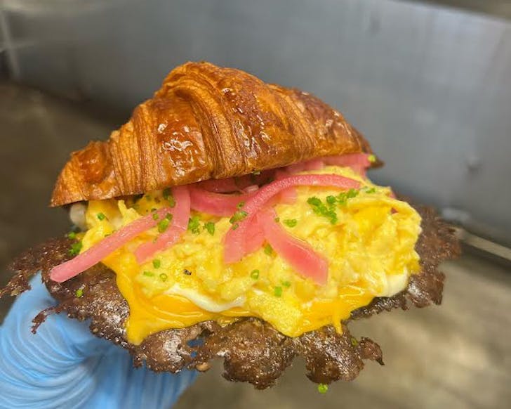 A golden croissant stuffed with American-style breakfast goodness at Baby G Burger. 
