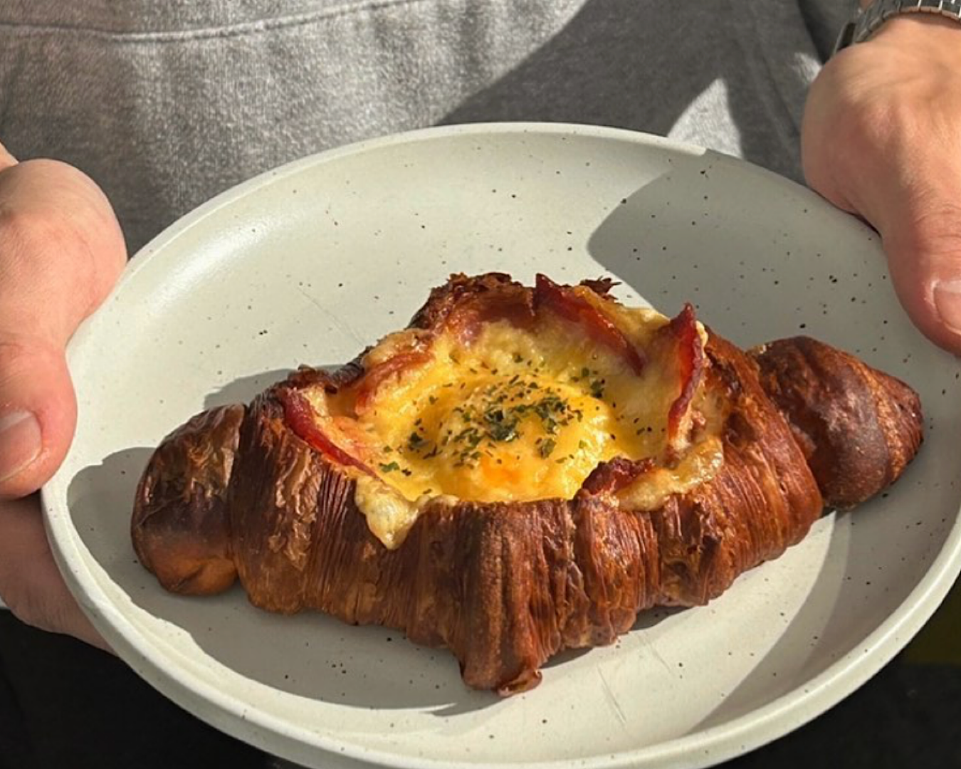 Bacon and egg croissant from Kompass Coffee, one of the best cafes to eat at this Easter long weekend. 