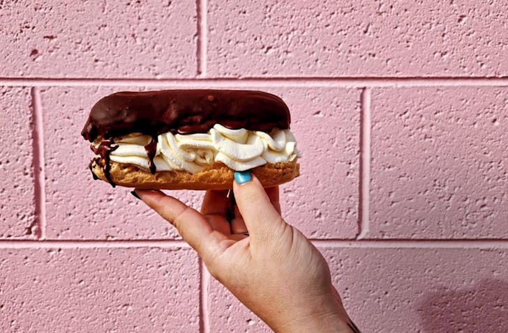 Person holding eclair. 
