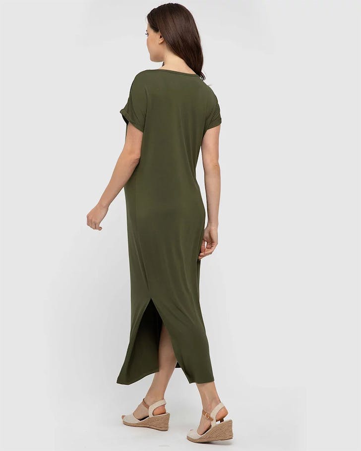 A pregnant woman wears a dark green bamboo jersey ankle-length dress with a side split. 
