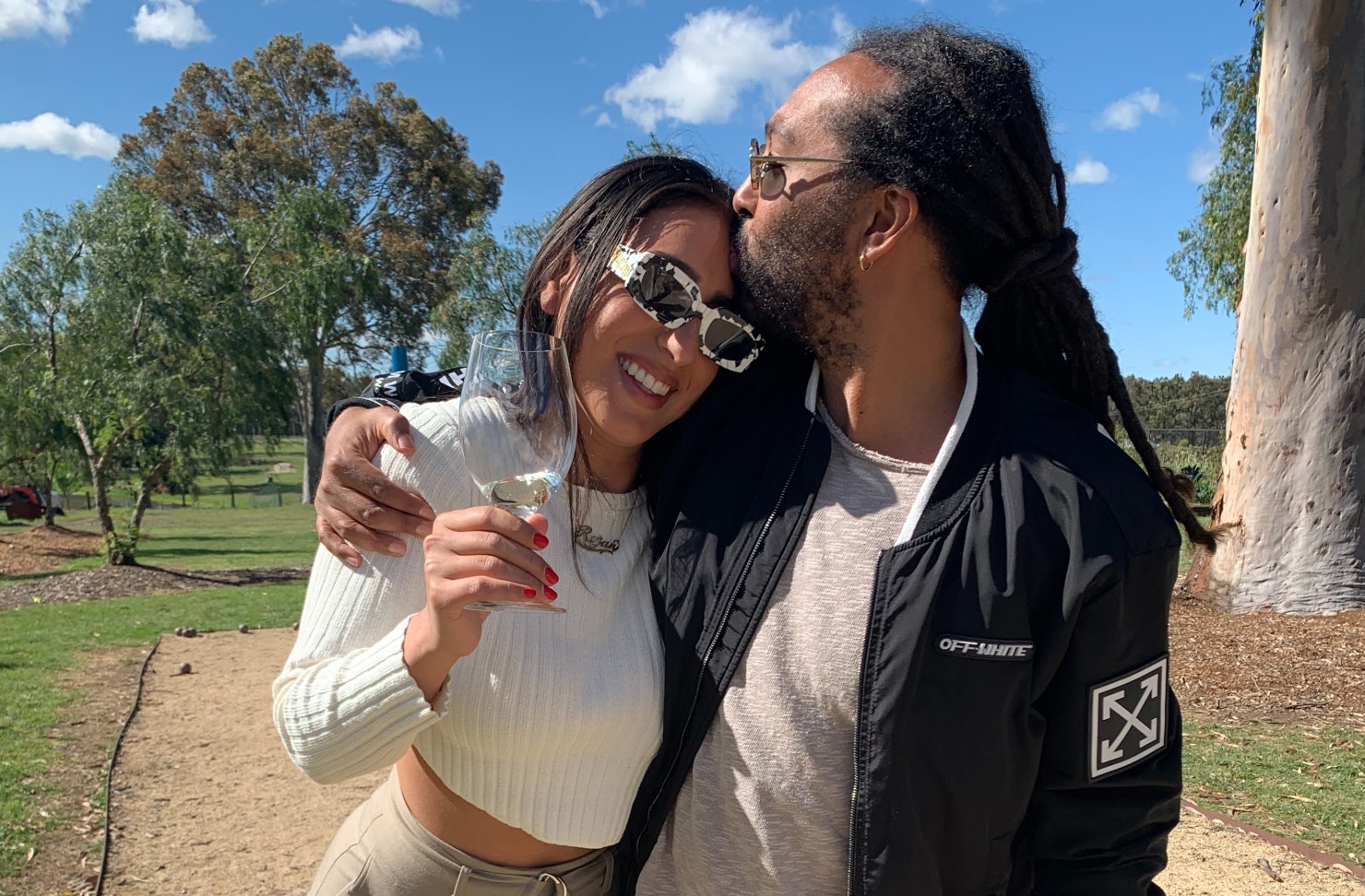 A couple kissing outside at a winery