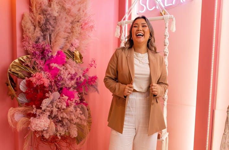 Maria Tong stands in her gorgeous pink ice cream store. 