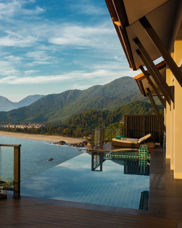 A view of a villa with an infinity pool overlooking the ocean at Banyan Tree Lang Co one of the best Vietnam resorts