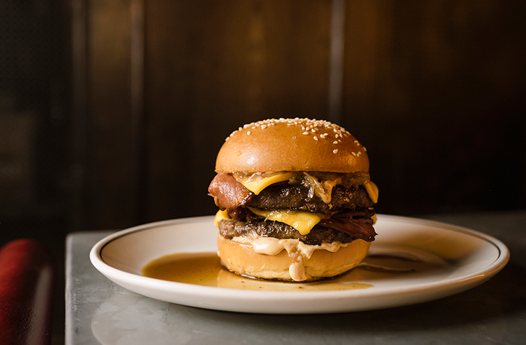 A burger stuffed with double beef patties, bacon, cheese and sauce oozing out, making this one of the best burgers in Melbourne