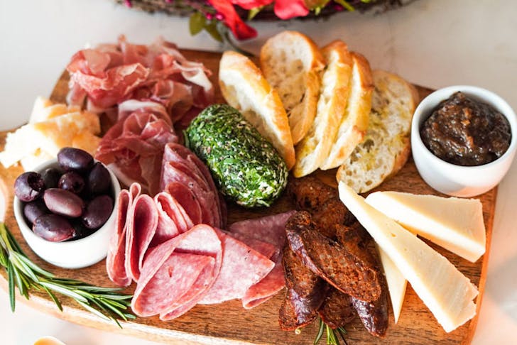 A charcuterie board with Italian-style snacks