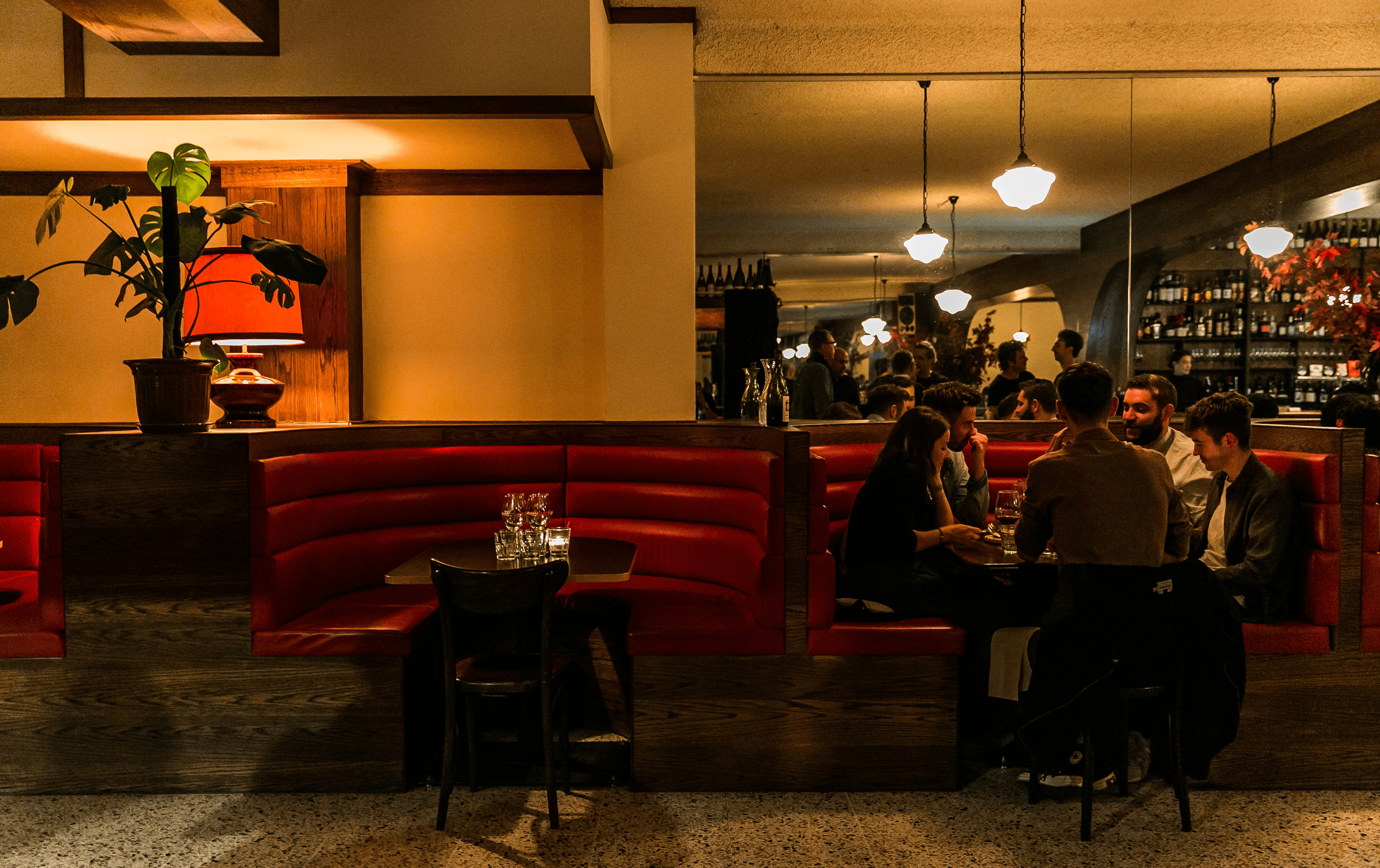 A booth with people drinking inside one of the best bars in Melbourne. 