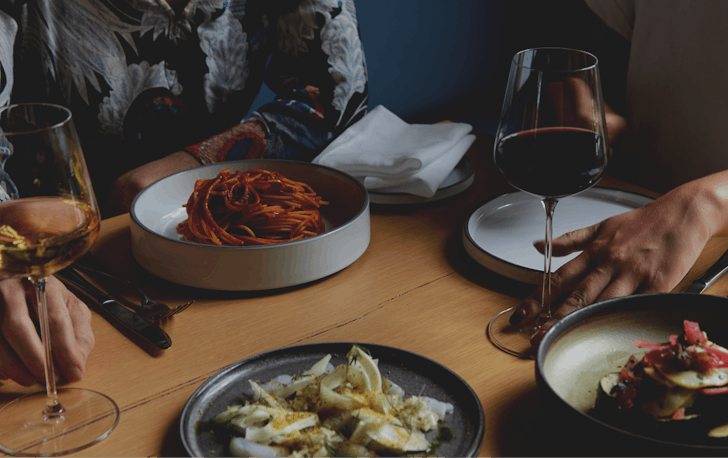 A table of different dishes and wine at one of Fitzroy's best restaurants. 
