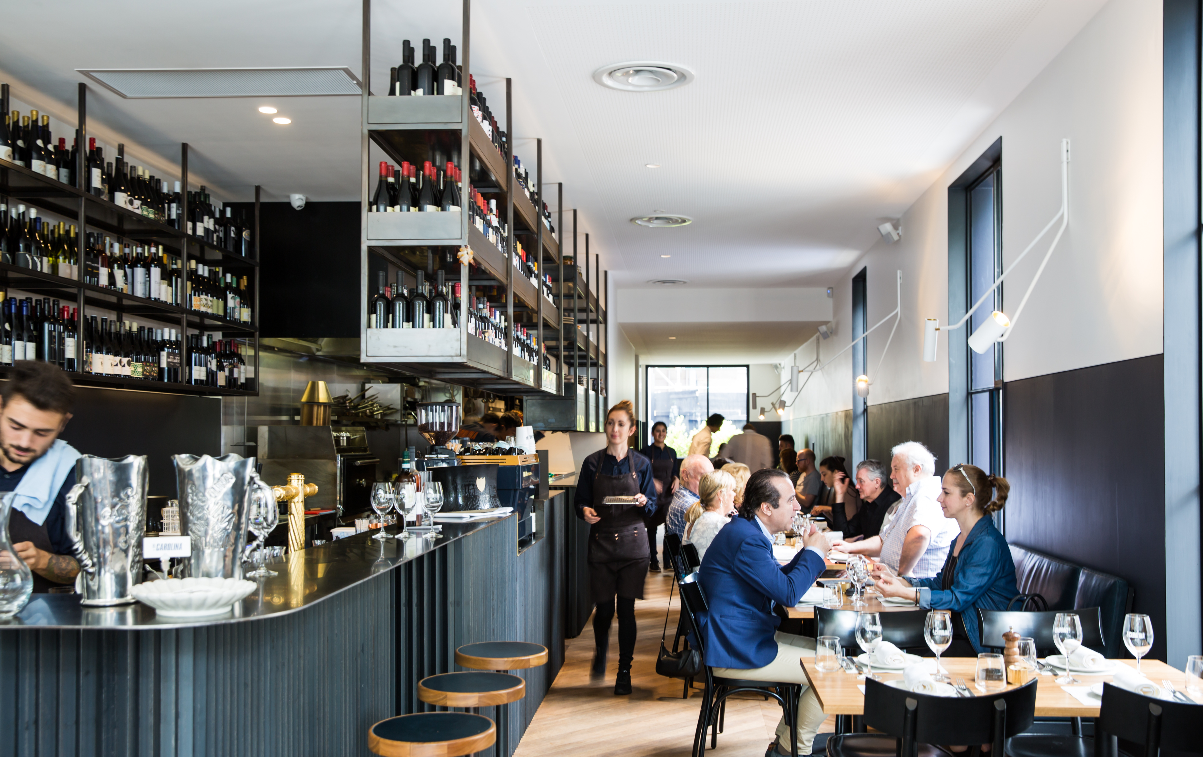 People dining in a sunlit Italian restaurant in Melbourne, Bar Carolina.