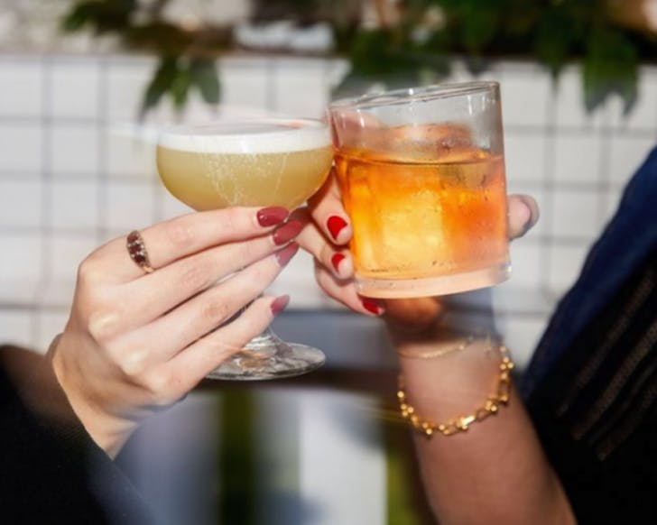 Clinking cocktails in celebration of happy hour at Bar Non Solo.