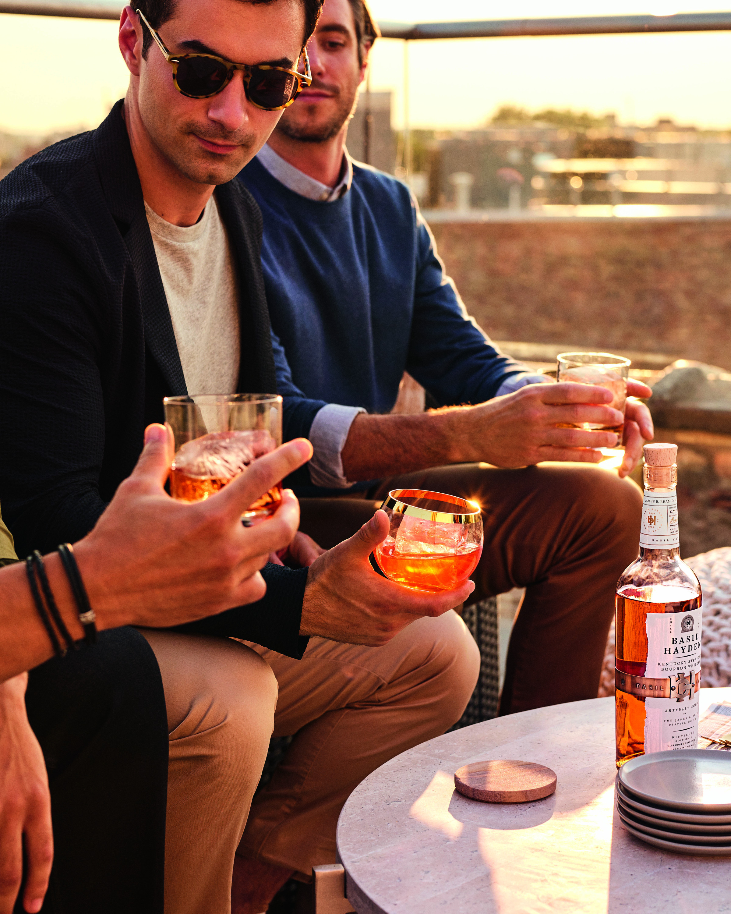 Men on rooftop drinking Basil Hayden.