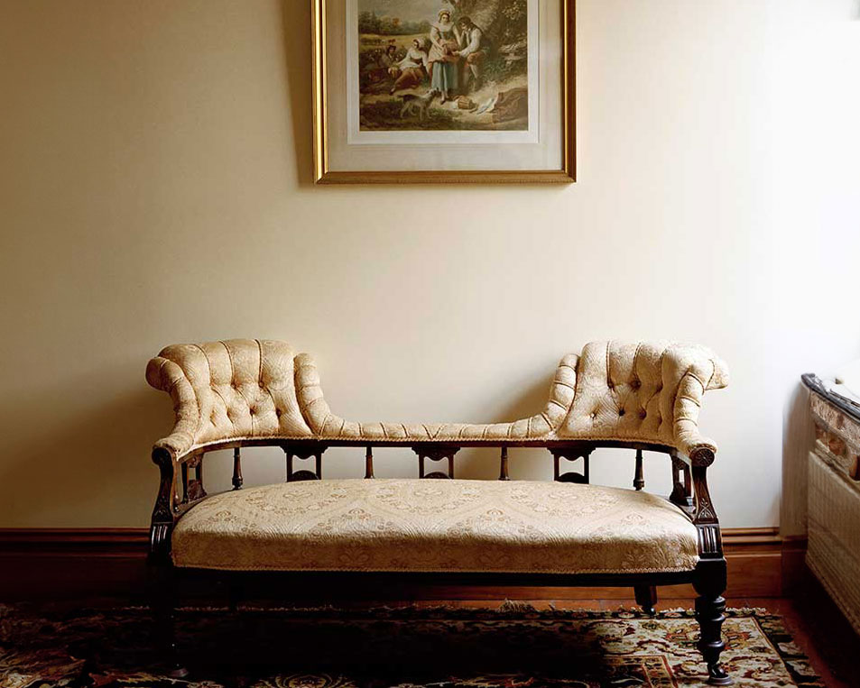 An old fashioned sofa under a painting at Braemar On Parliament St.