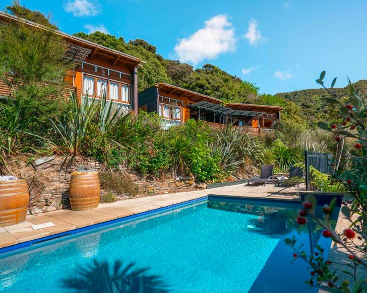 Luxury suites overlook a blue pool at the Bay of Many Coves, one of the best luxury hotels in New Zealand.