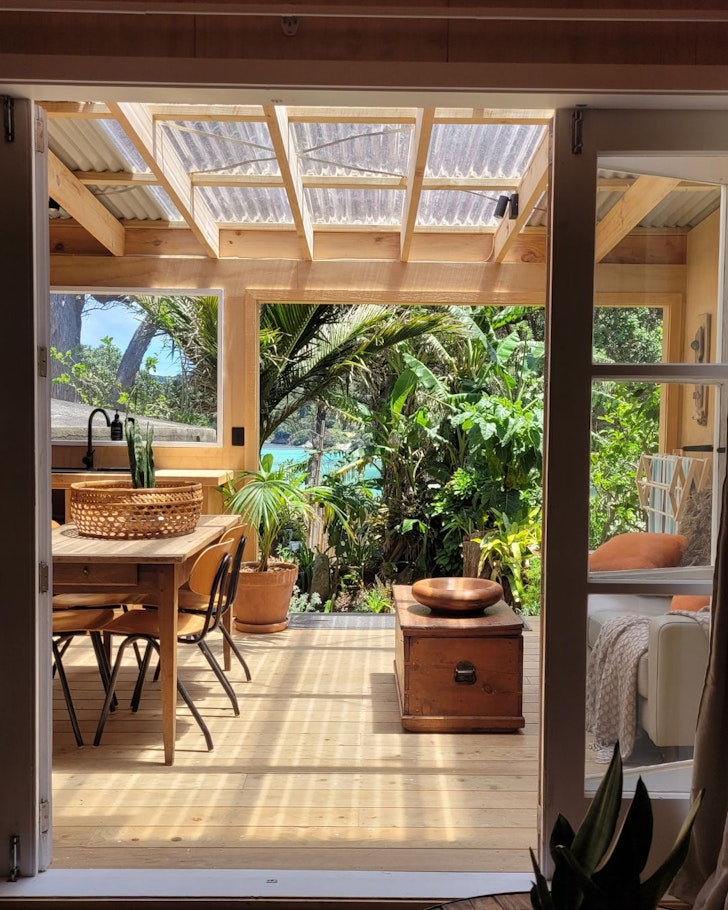 The tropical living space at Bay Cottage best NZ beach house Airbnbs