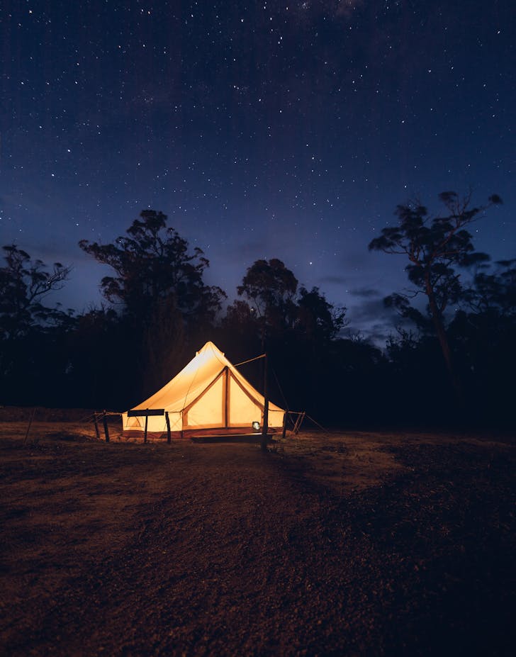 A tent aglow, beneath a blanket of stars in Tasmania.