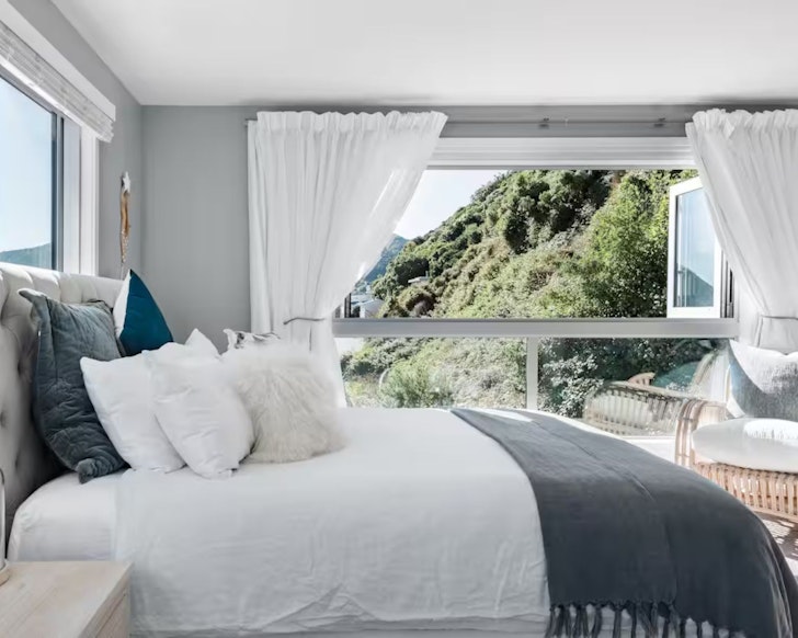 The bedroom with a view at the Bayside Gem Airbnb one of the most romantic stays in Wellington