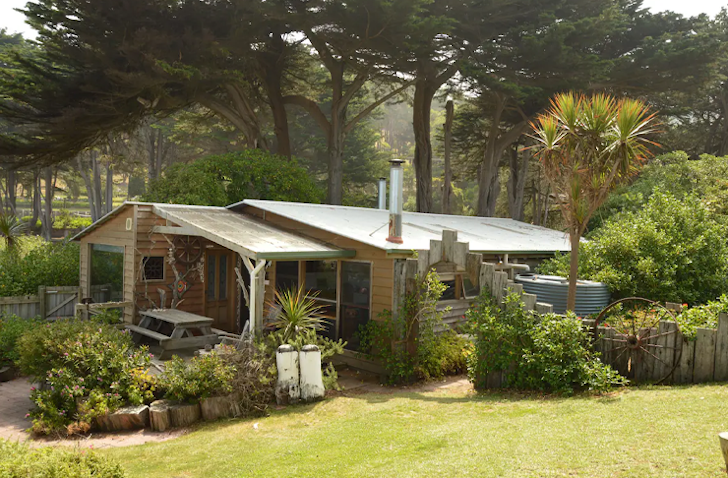 An exterior view of Beach Cottage At Kookaburra Wellness Retreat surrounded by trees