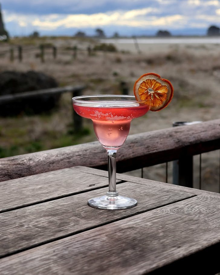 A beautiful, rose-tinted cocktail by the water at Beach Sumner. 