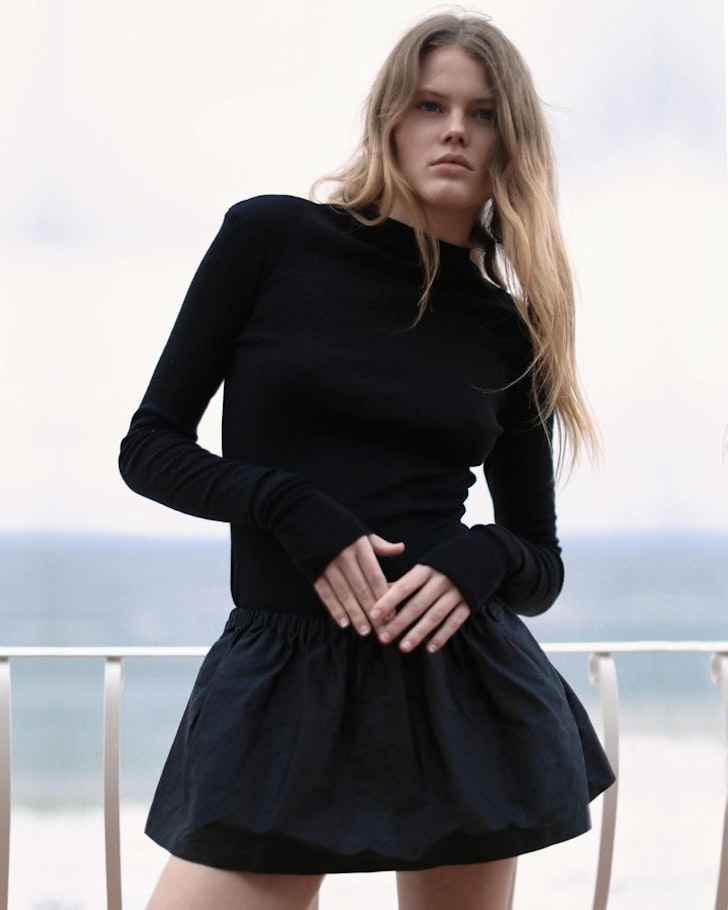 A model wears a black minidress from Beare Park one of the best Australian fashion labels