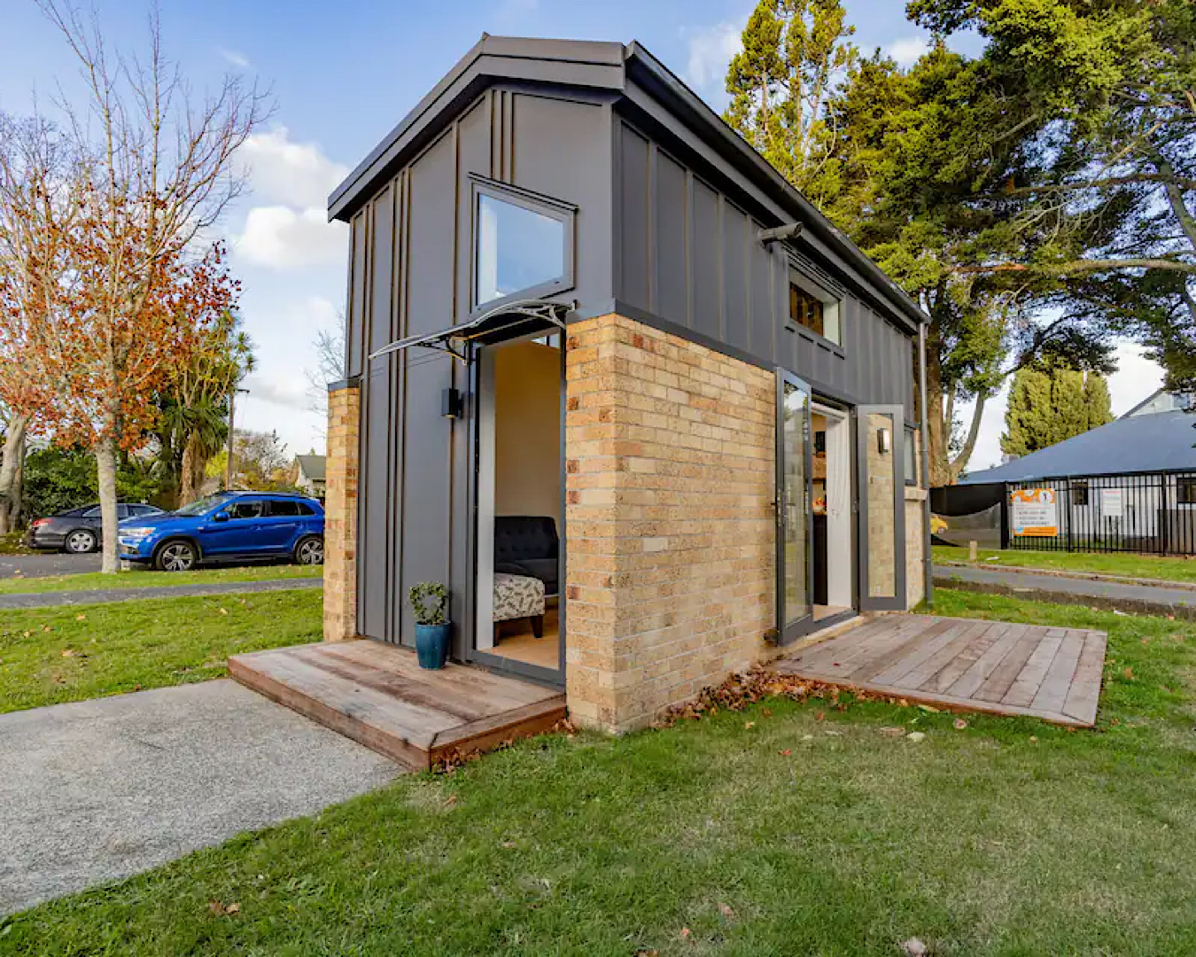 An impressively modern tiny house sits on a lawn in a quiet cul-de-sac in Hamilton. 
