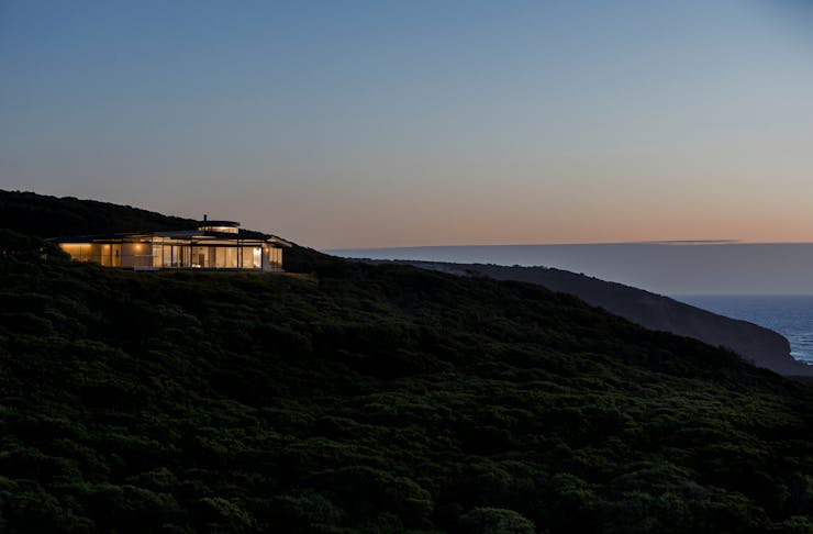 An airbnb on a hill overlooking the ocean.
