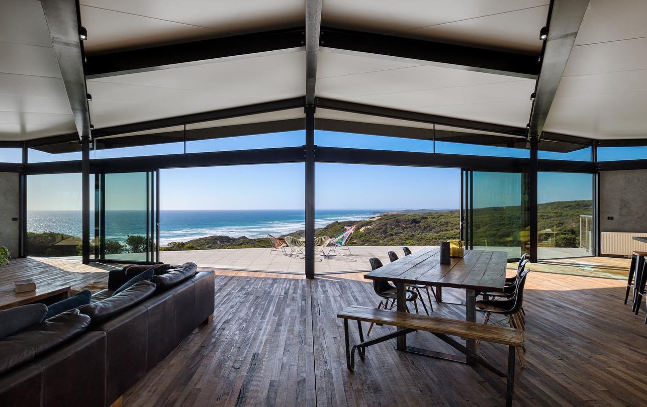 A large indoor lounge room looking out to the ocean at the best airbnb in Victoria for 2023.