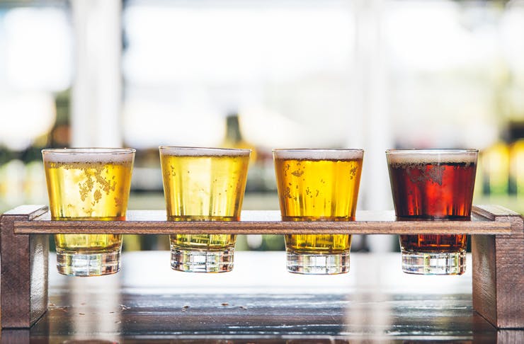 Four Beers in a wooden tasting tray