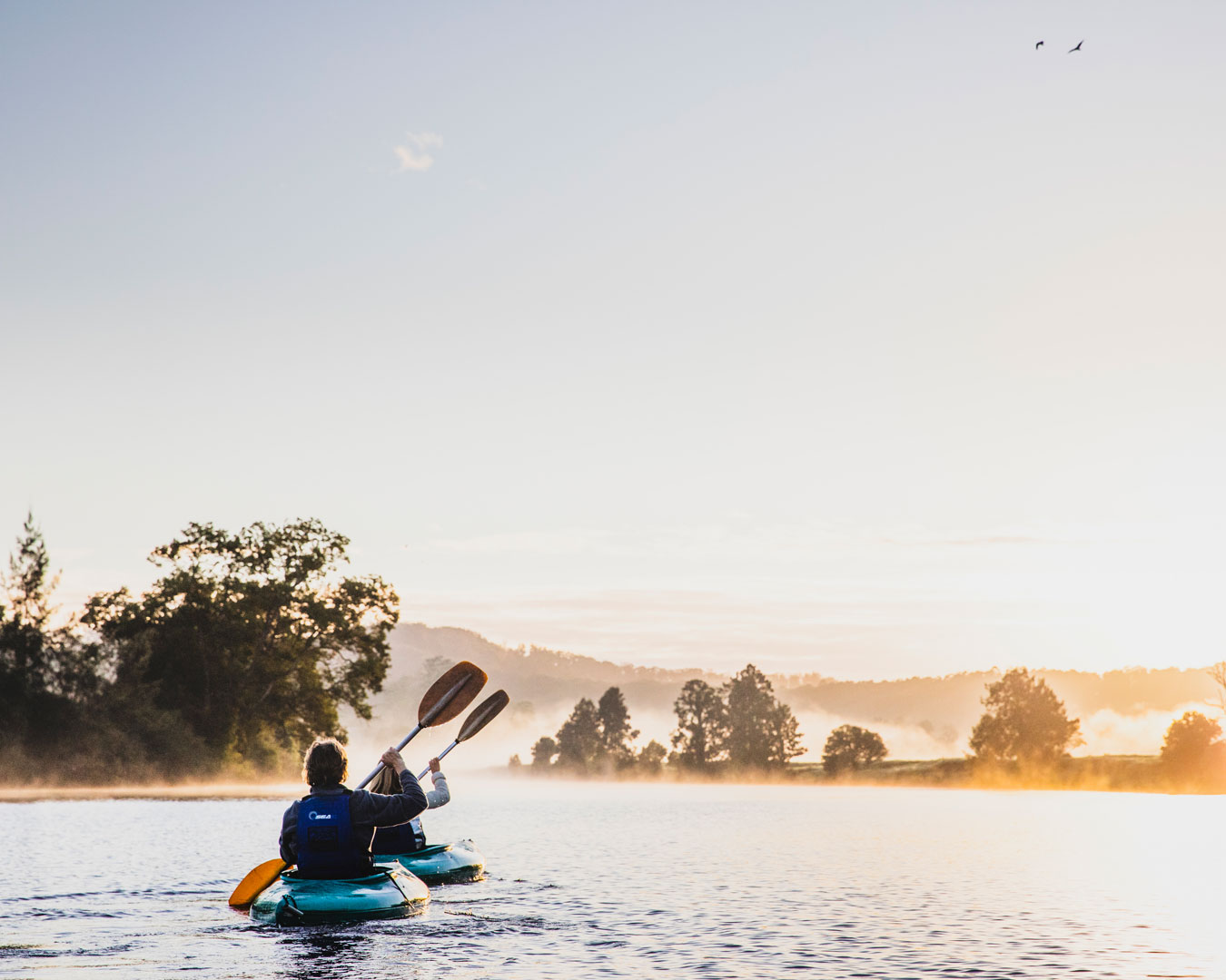 People kayaking on river