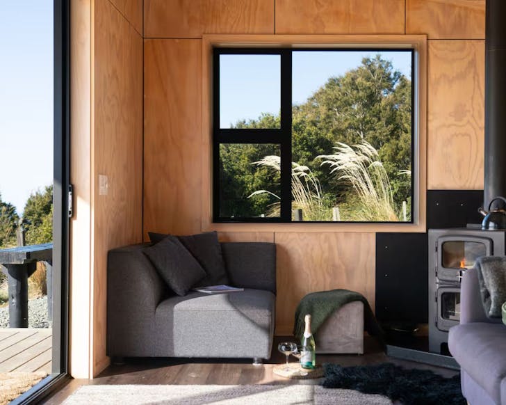 A view of the fire and living space at Beresford Heights, one of the best Airbnbs in New Zealand