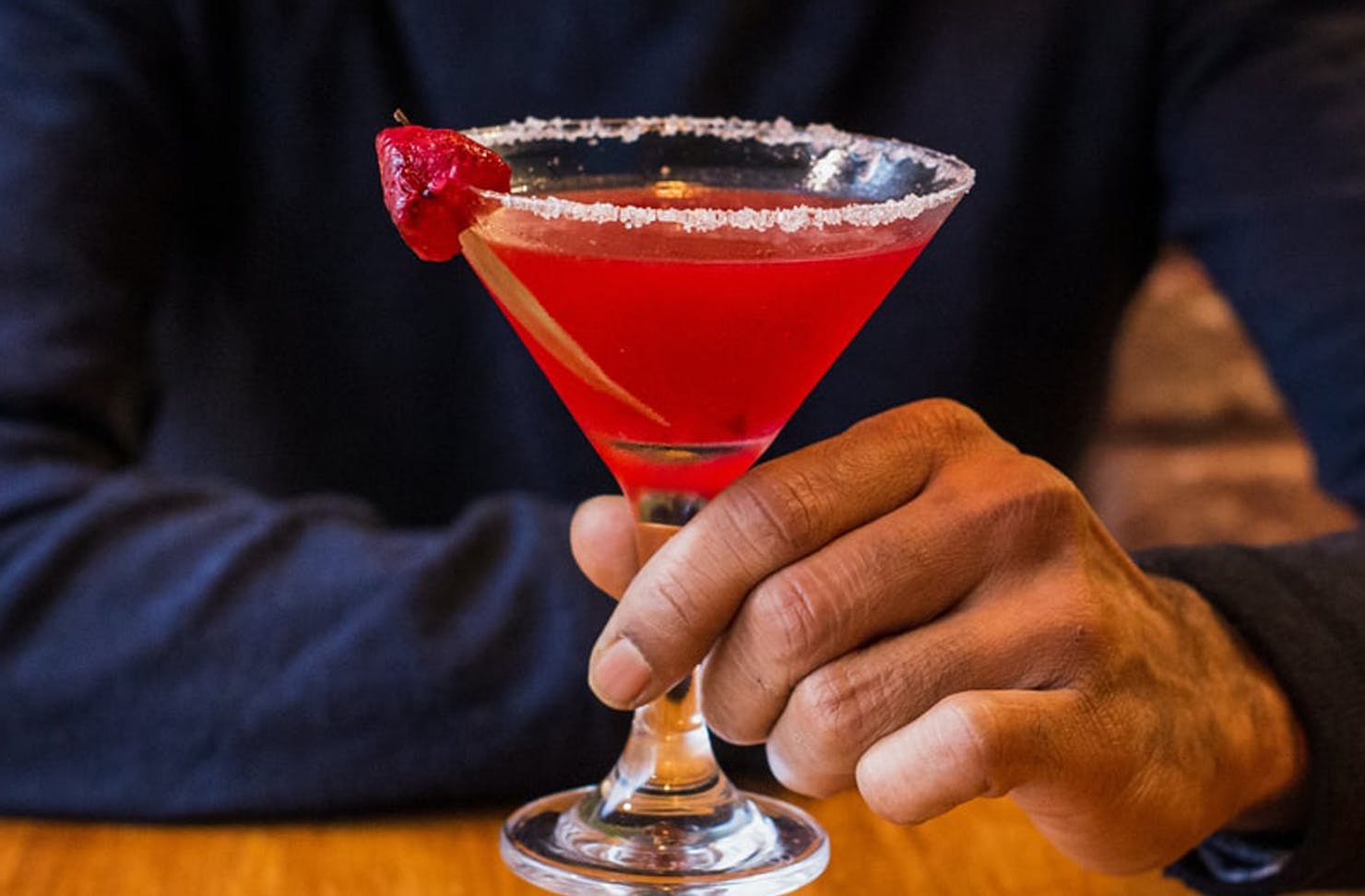 Man holding a pink berry margarita.