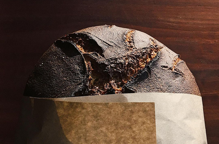 A shot of a loaf of sourdough in a paper bag.