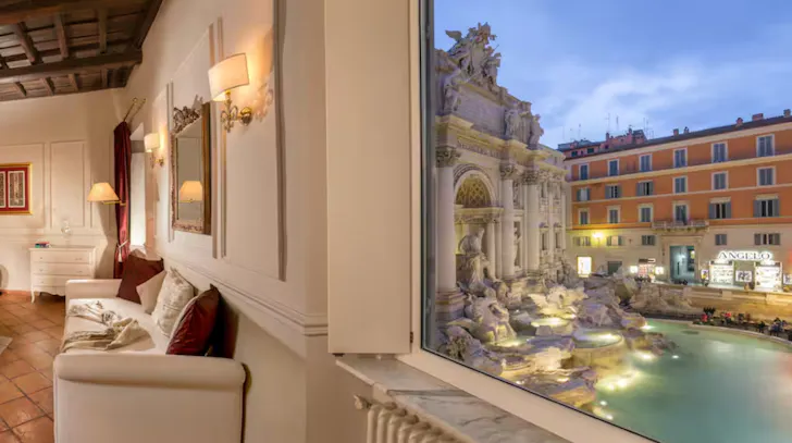 Airbnb in Rome with Trevi Fountain view from apartment window at night