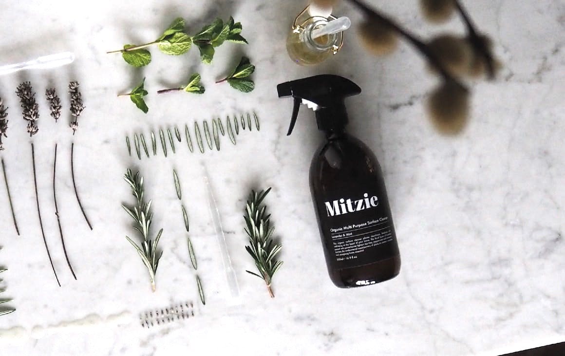 Flat lay of an amber bottle with ingredients to make your own eco-friendly cleaning products