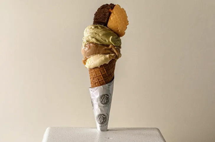Best gelato in Rome from Come Il Latte with pistachio, chocolate and cream scoops in waffle cone