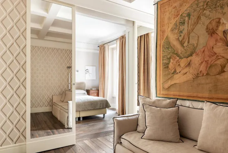 Best hotels in Rome at Casa Montani with classic bedroom, antique furnishings and soft neutral tones