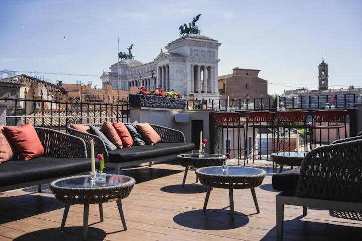 Best hotels in Rome at Otivm Hotel with a rooftop terrace dining and lounge area overlooking the Capitoline Hill