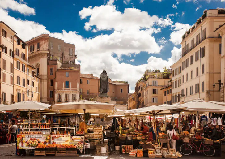 Best markets in Rome at Campo de' Fiori with bustling market stalls in a Roman courtyard