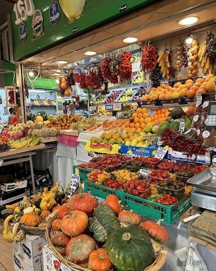 Best markets in Rome at Mercato Trionfale with a stall showcasing a variety of fruit and vegetables