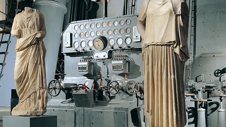 Ancient sculptural pieces set against industrial powerplant equipment at Centrale Montemartini, one of Romeâs best museums and galleries