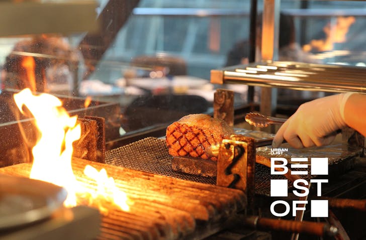 A chef cooking a piece of steak at WAKANUI Grill Dining