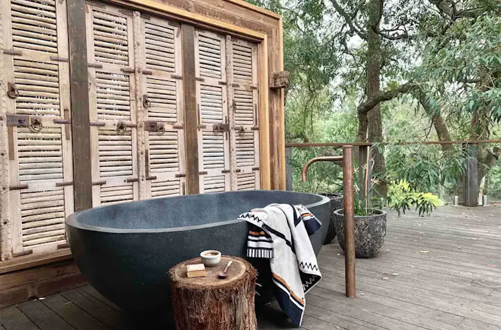 A view of the stone outdoor bath at The Treehouse pet-friendly stay near Sydney