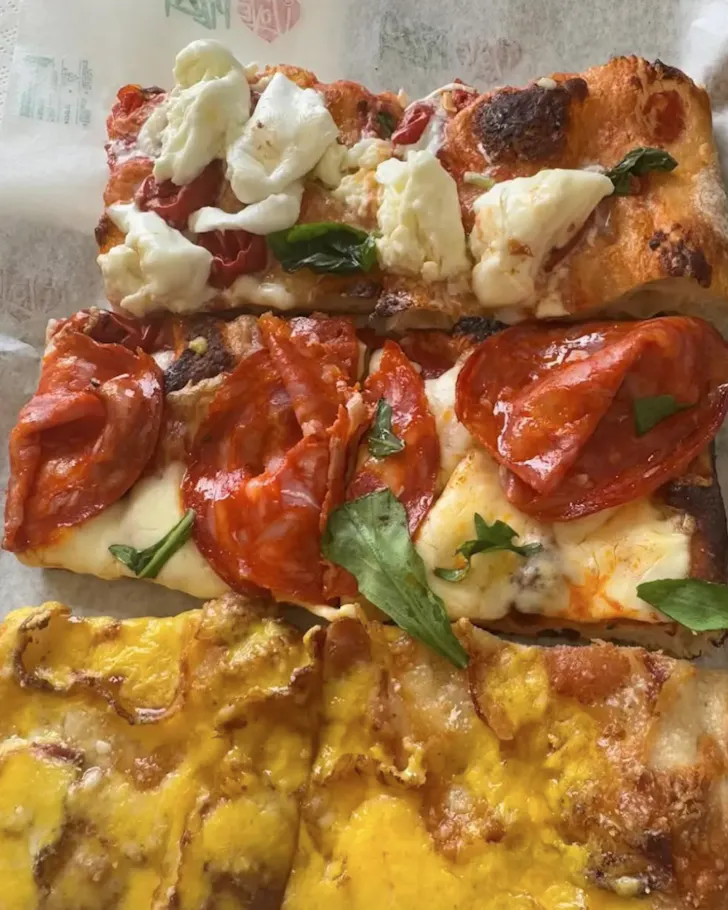 Best pizza in Rome at Pizza Florida with rustic slices of square pizza with various toppings