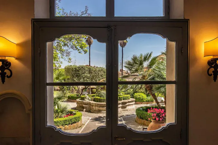 Best places to stay in Rome at Trastevereâs Donna Camilla Savelli with heritage windows looking out over a terrace garden