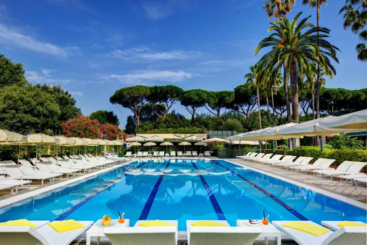 Best places to stay in Rome at Parco dei Principi Grand Hotel & Spa in Parioli with a huge outdoor pool surrounded by sun beds, umbrellas and trees