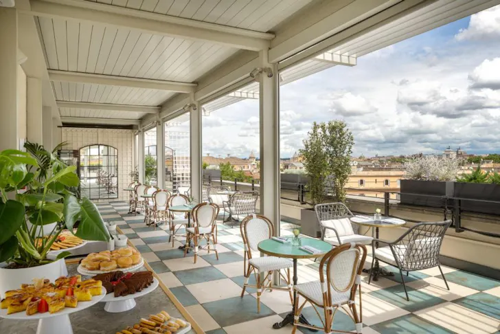 Best places to stay in Rome at Trastevere Roma with breakfast in a dining room looking out over Romeâs rooftops