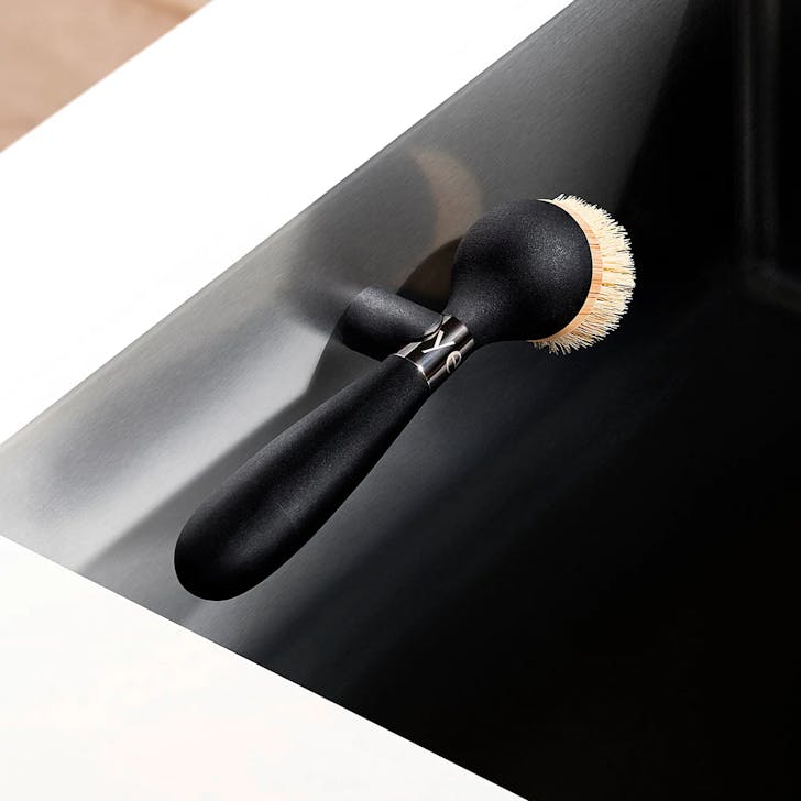 The One Brush by yeseco in a kitchen sink on the magnetic stand