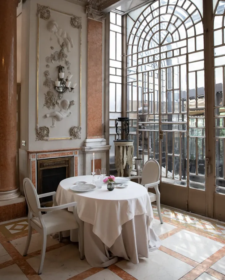 Best restaurants in Rome at Enoteca La Torre with a beatiful set table for two in an ornate dining room