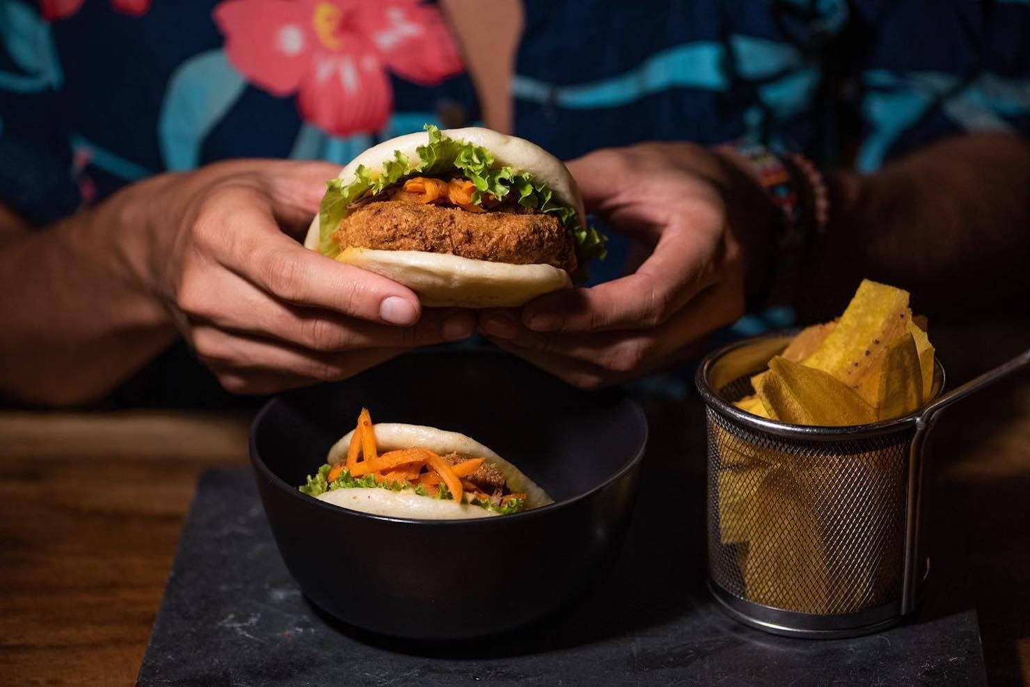 A person holding a bao bun at Katana in Santa Teresa